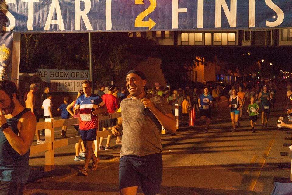 man running across finish line