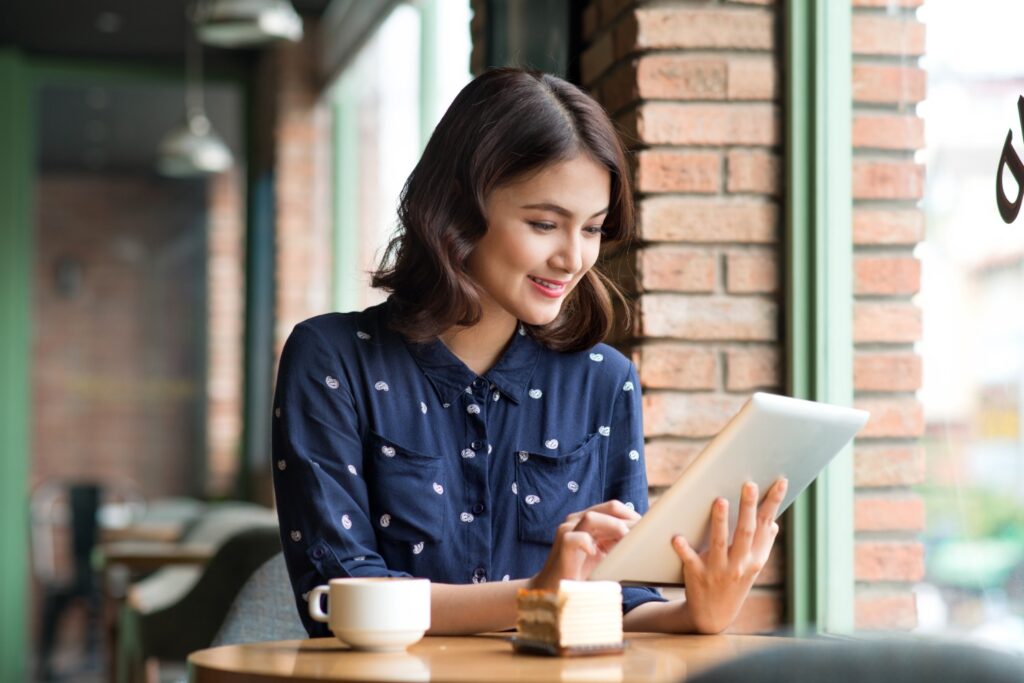 Girl on a tablet at a coffee shop