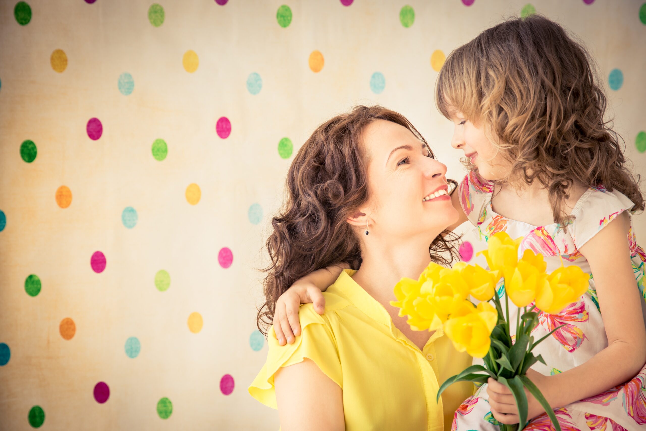 Mother and daughter holding a bouquet of flowers