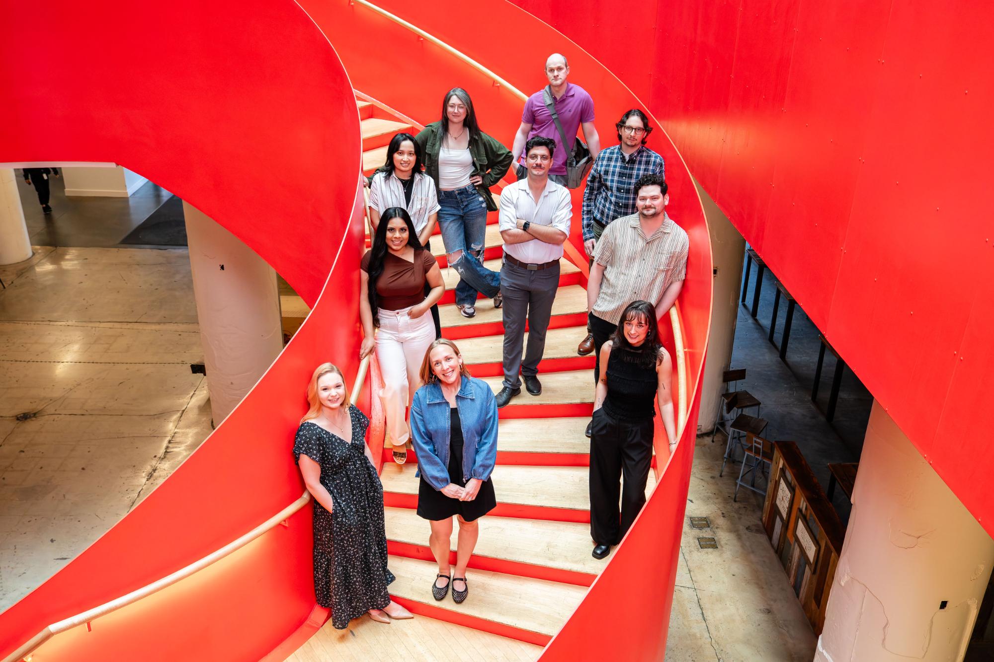neon canvas group on spiral staircase