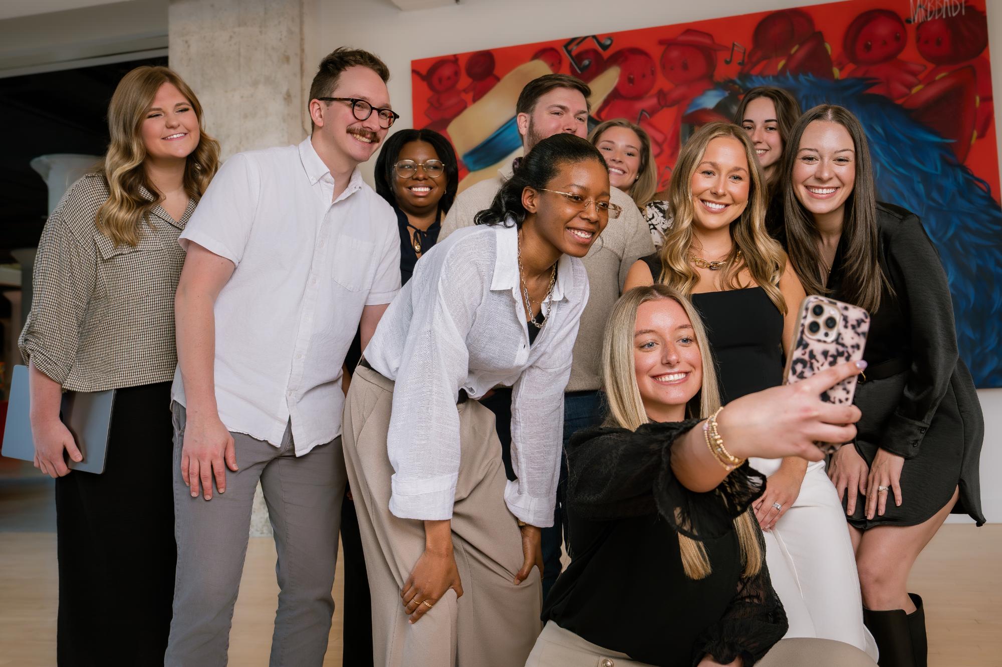 neon canvas group selfie photo